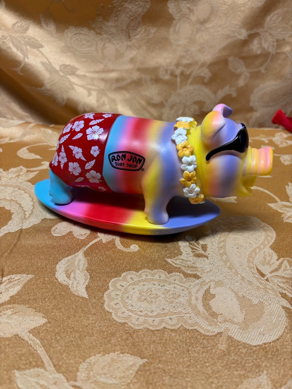 Ron Jon surf shop snorting pig on a surfboard